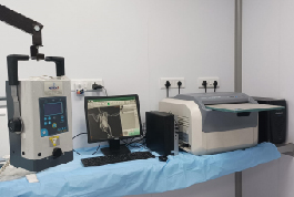 A well-equipped medical room displaying a computer, printer, and additional equipment, part of Shree Danev Foundation's X-Ray unit.