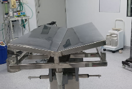 A large metal V-shaped operation table in a hospital room, designed for surgical procedures by Shree Danev Foundation.