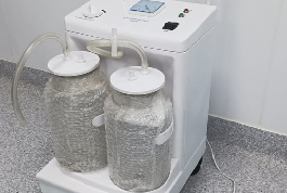 A suction machine from the Shree Danev Foundation, featuring two bottles positioned on top for medical use.