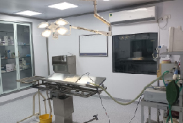 Interior of a hospital room with medical equipment and a bed, highlighting the modular operation theater by Shree Danev Foundation.