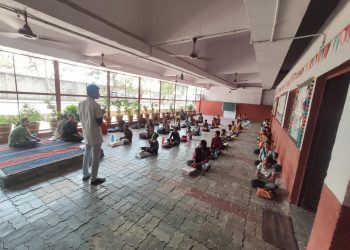 A classroom scene with children on the floor, actively involved in the Shree Danev Foundation's Animal Welfare Awareness Camp.